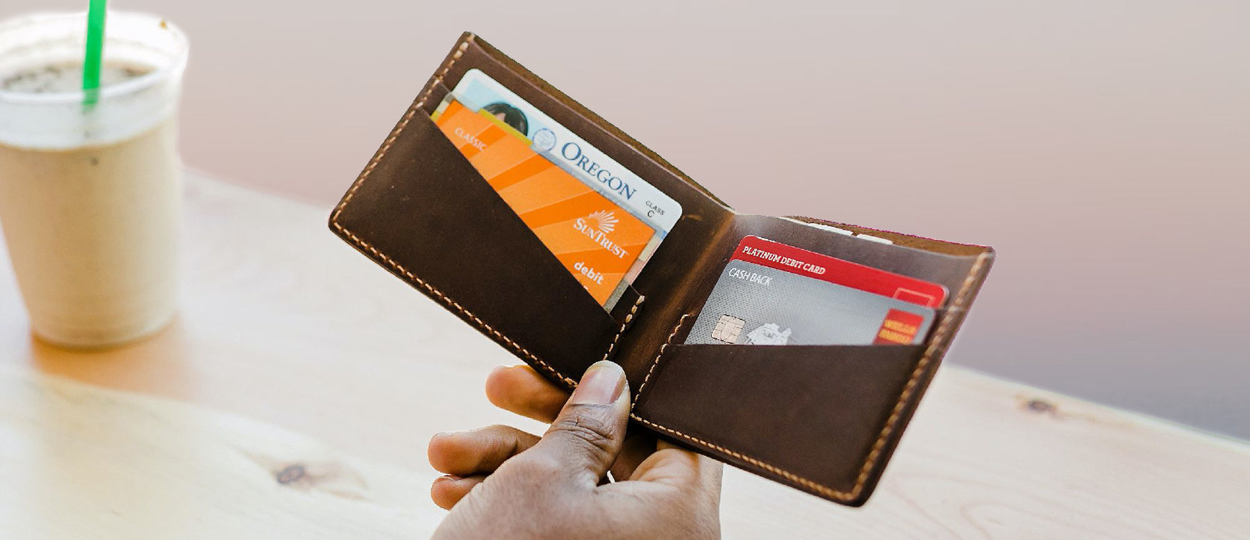 Men's Leather Wallets bifold being held in a coffee shop