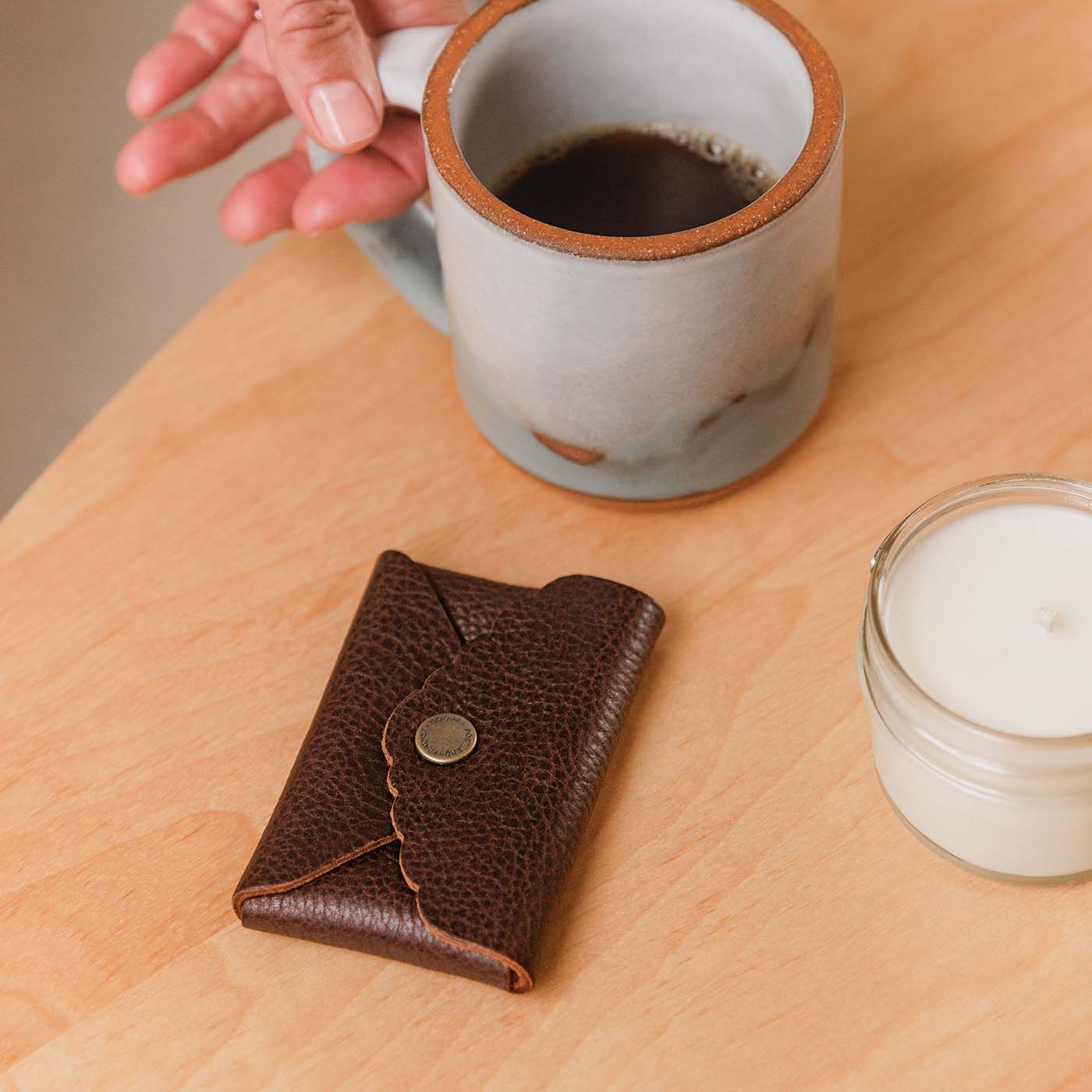 Coldbrew | Small leather wallet with scalloped edge next to coffee mug