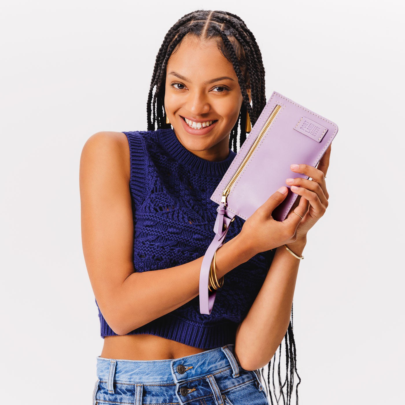 Lavender | Model holding flat leather pouch with zipper and wristlet