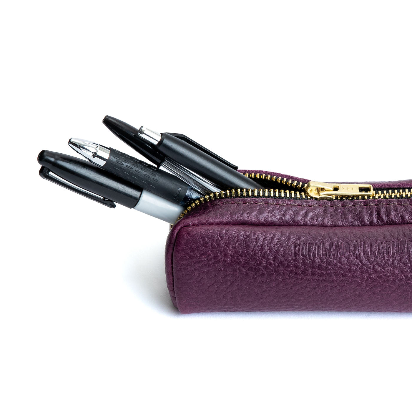 All Color: Plum | Leather pouch with a curved top and zipper