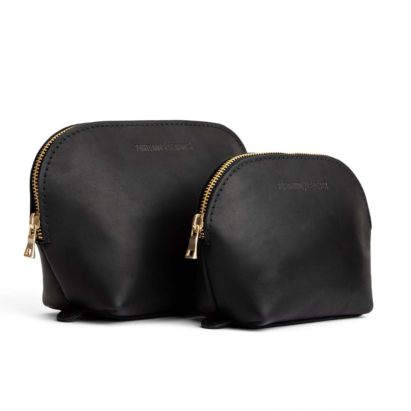 Black | Leather makeup bag with curved top zipper and flat bottom