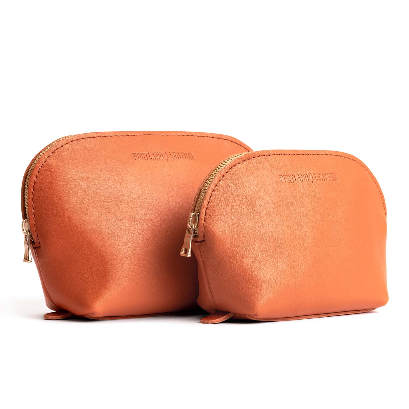 Persimmon | Leather makeup bag with curved top zipper and flat bottom