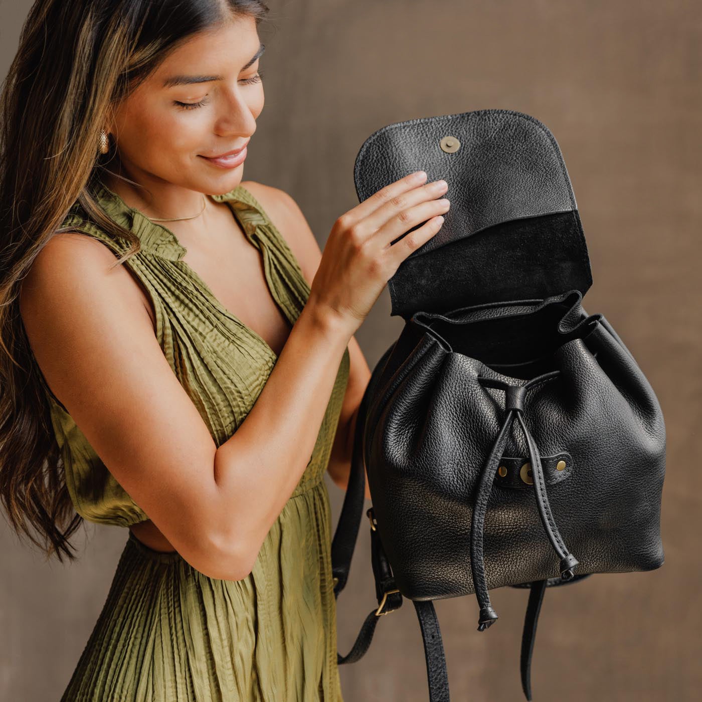 All Color: Pebbled--black | Model holding slouchy leather bucket backpack