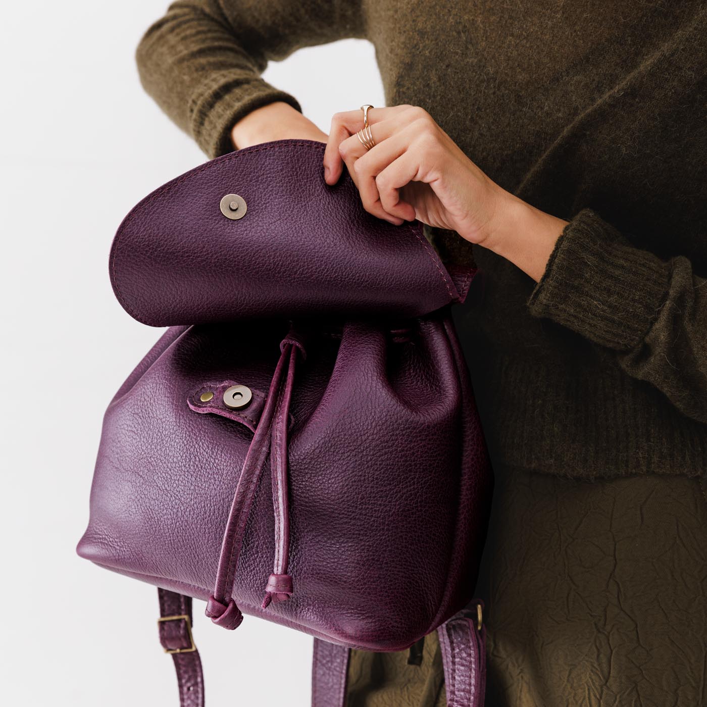 All Color: Plum | Model holding slouchy leather bucket backpack