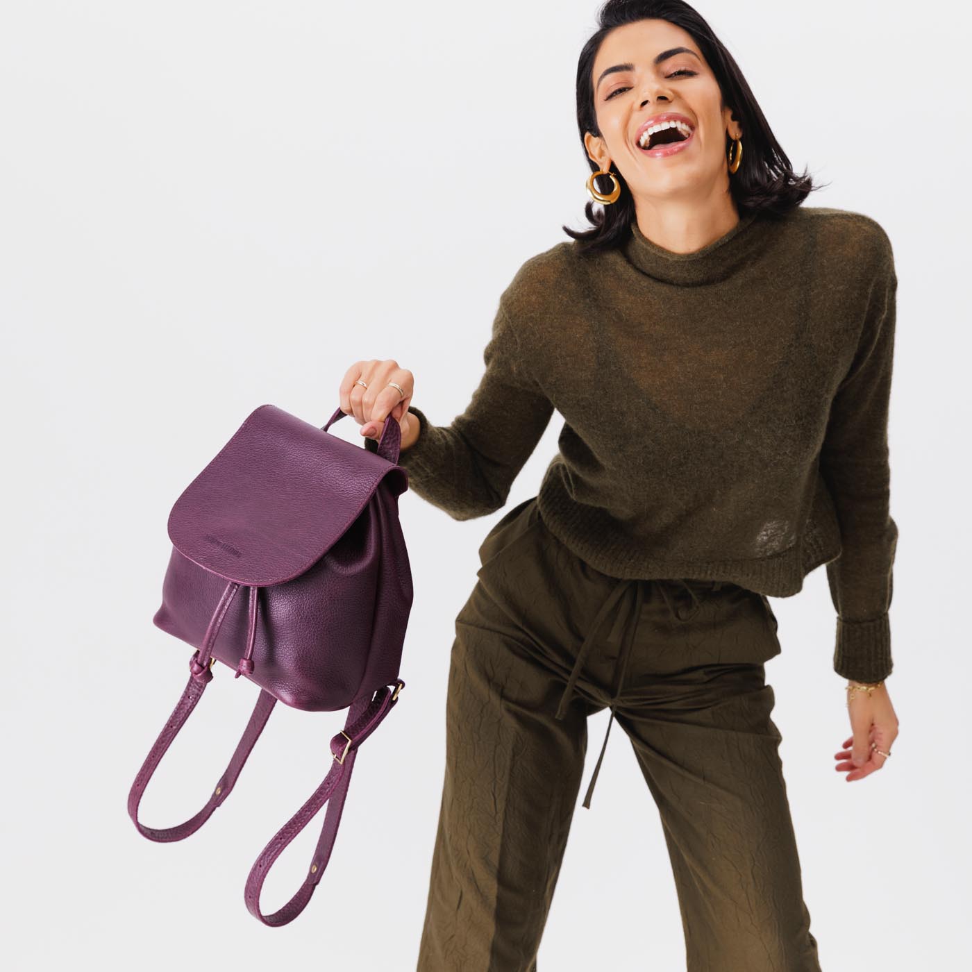 All Color: Plum | Model holding slouchy leather bucket backpack