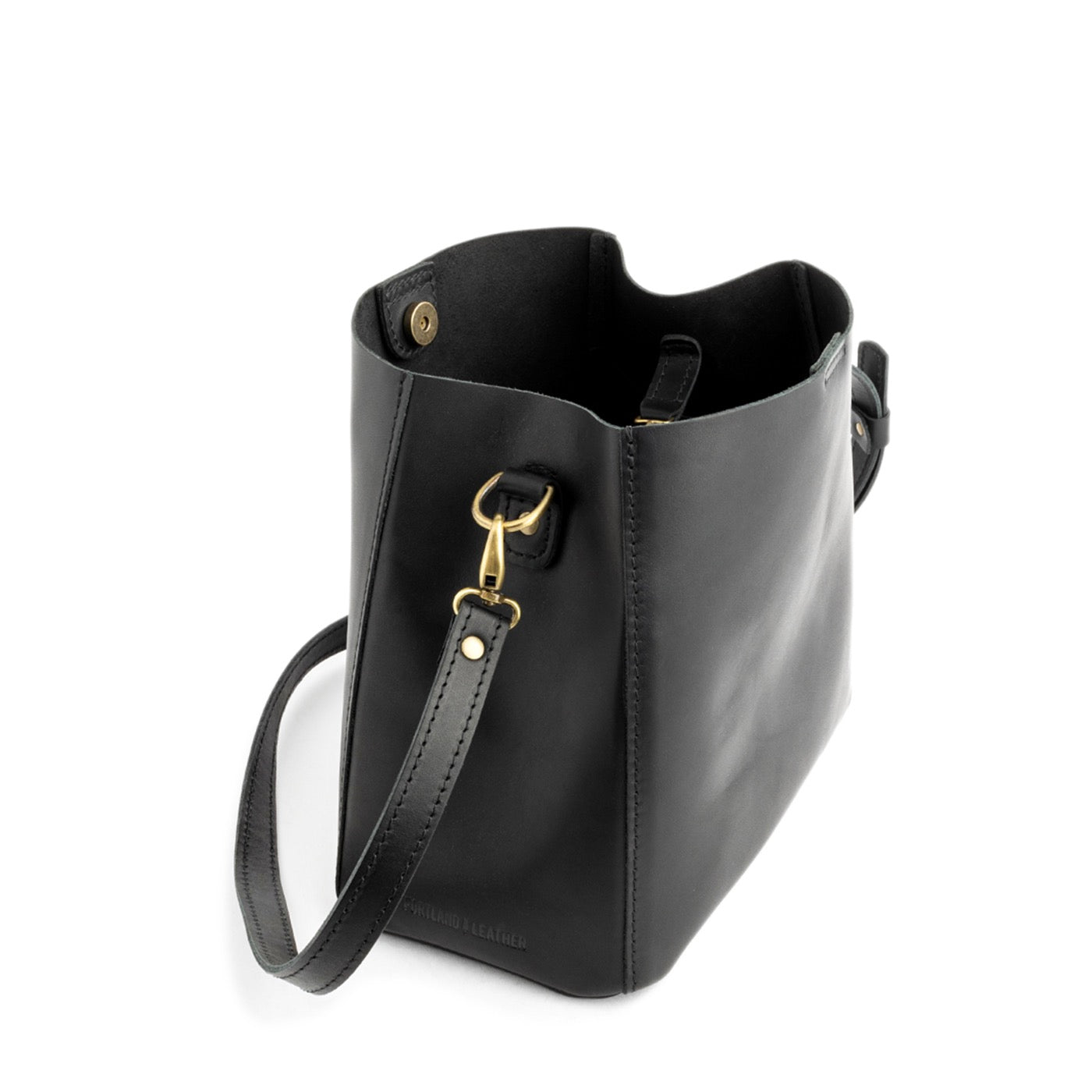 Black | symmetrical bucket bag with latch closure and removable crossbody strap