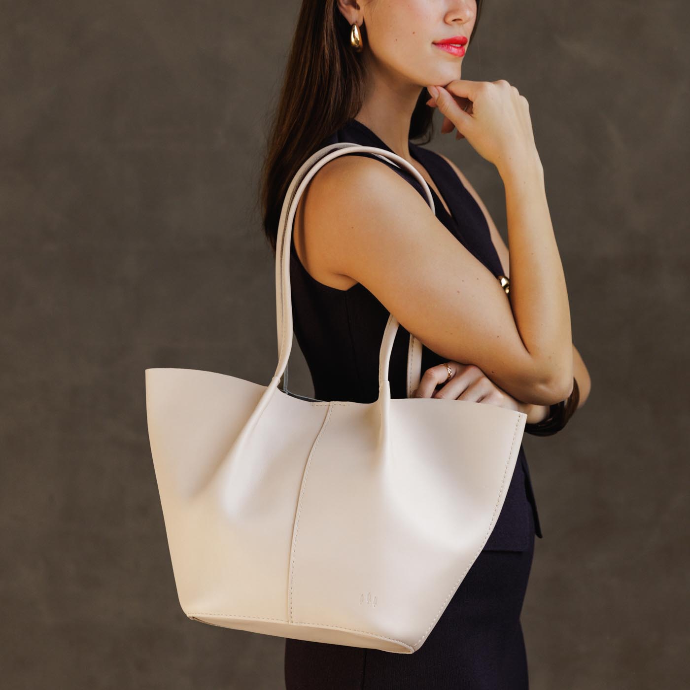 Bone*Large | Model holding wide bucket shaped tote bag with matching leather handles