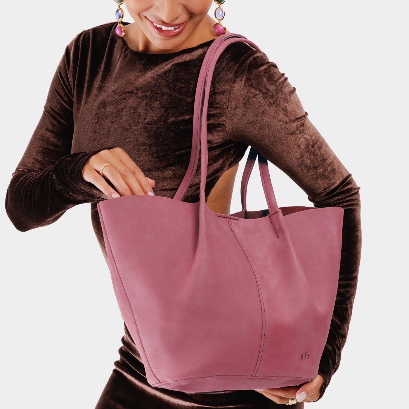 Foxglove*Large | Model holding wide bucket shaped tote bag with matching leather handles