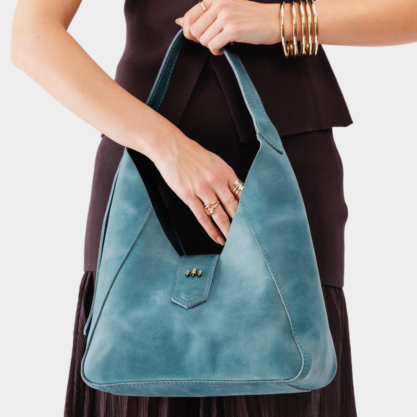 Aqua | Model holding structured hobo shoulder bag with adjustable strap and magnetic closure