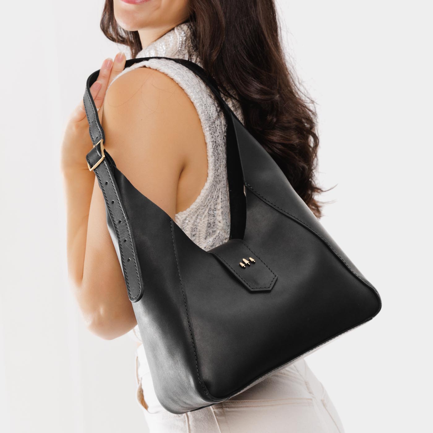 Black | Model wearing structured hobo shoulder bag with adjustable strap and magnetic closure