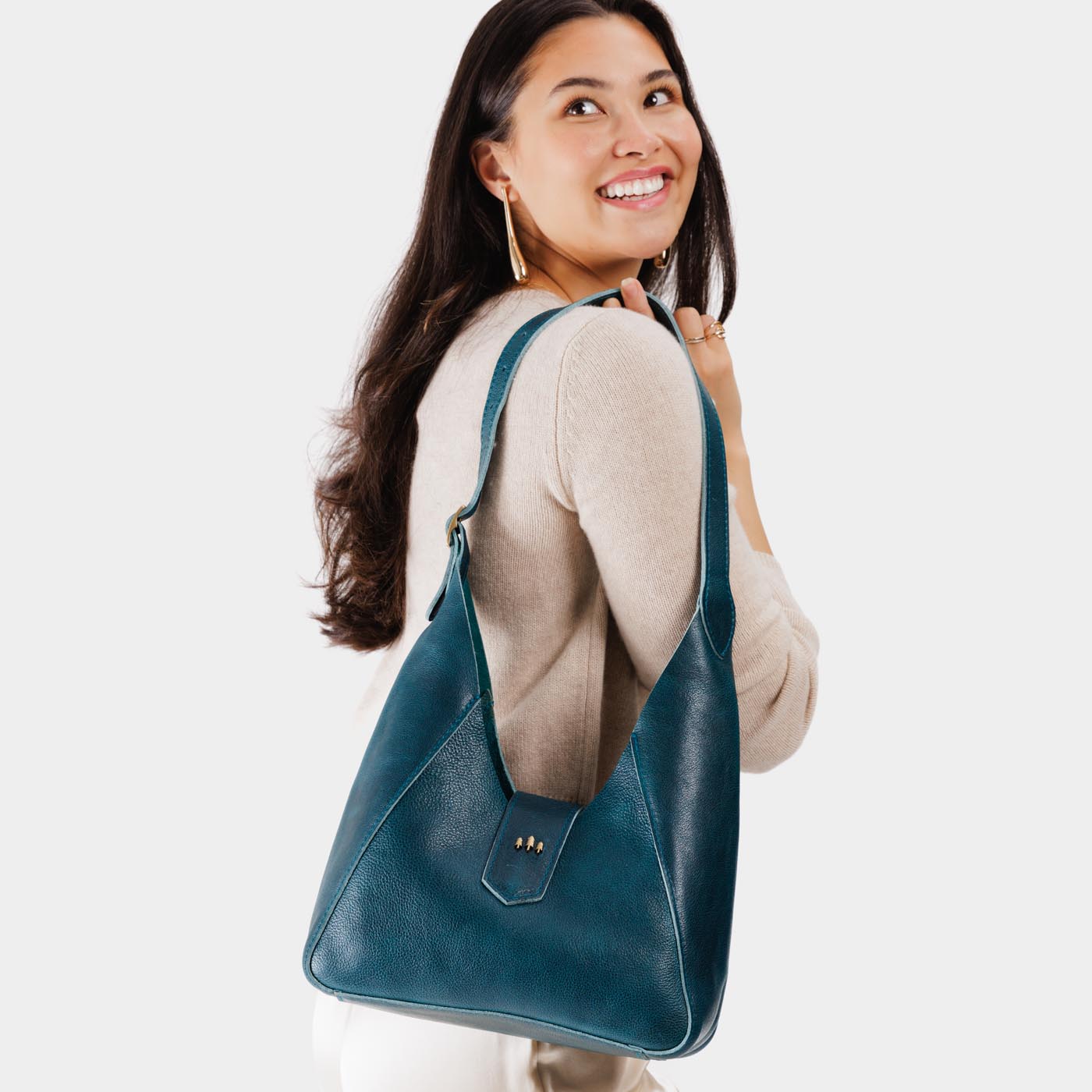 Lagoon | Model wearing structured hobo shoulder bag with adjustable strap and magnetic closure