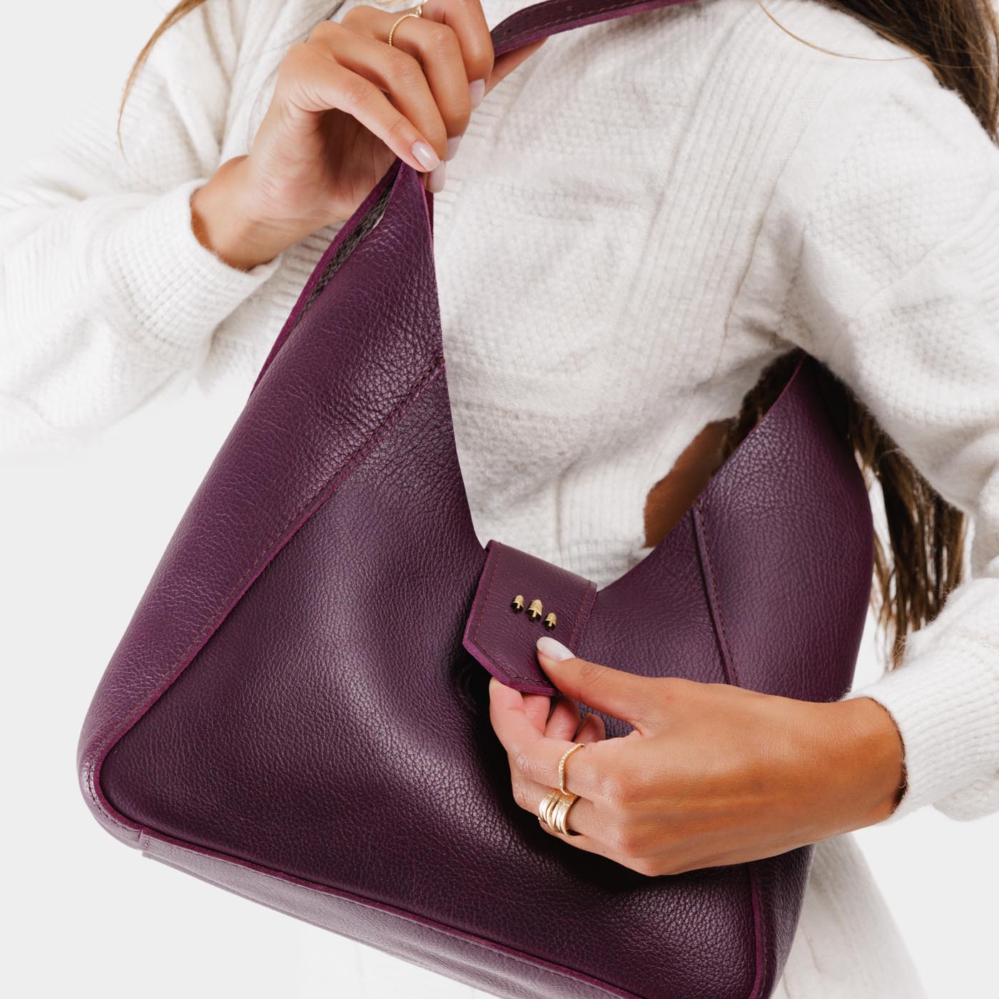 Plum | Model holding structured hobo shoulder bag with adjustable strap and magnetic closure