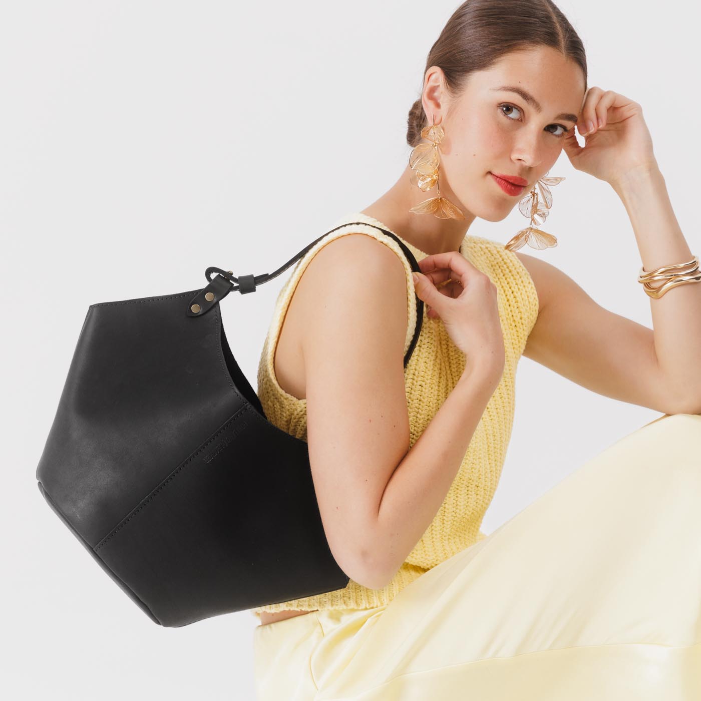 Black*Large | Structured bucket shaped handbag with an adjustable shoulder strap