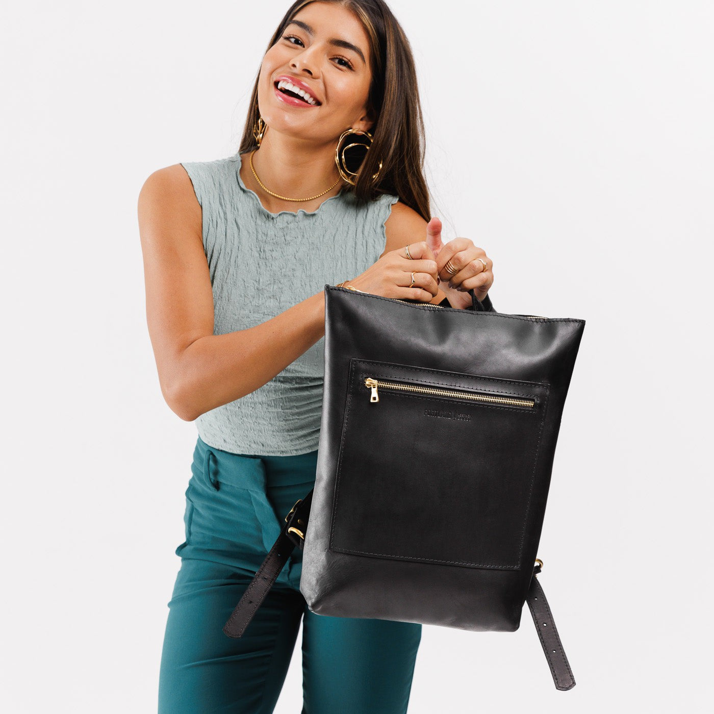 All Color: Black | Model holding rectangular slim leather laptop backpack