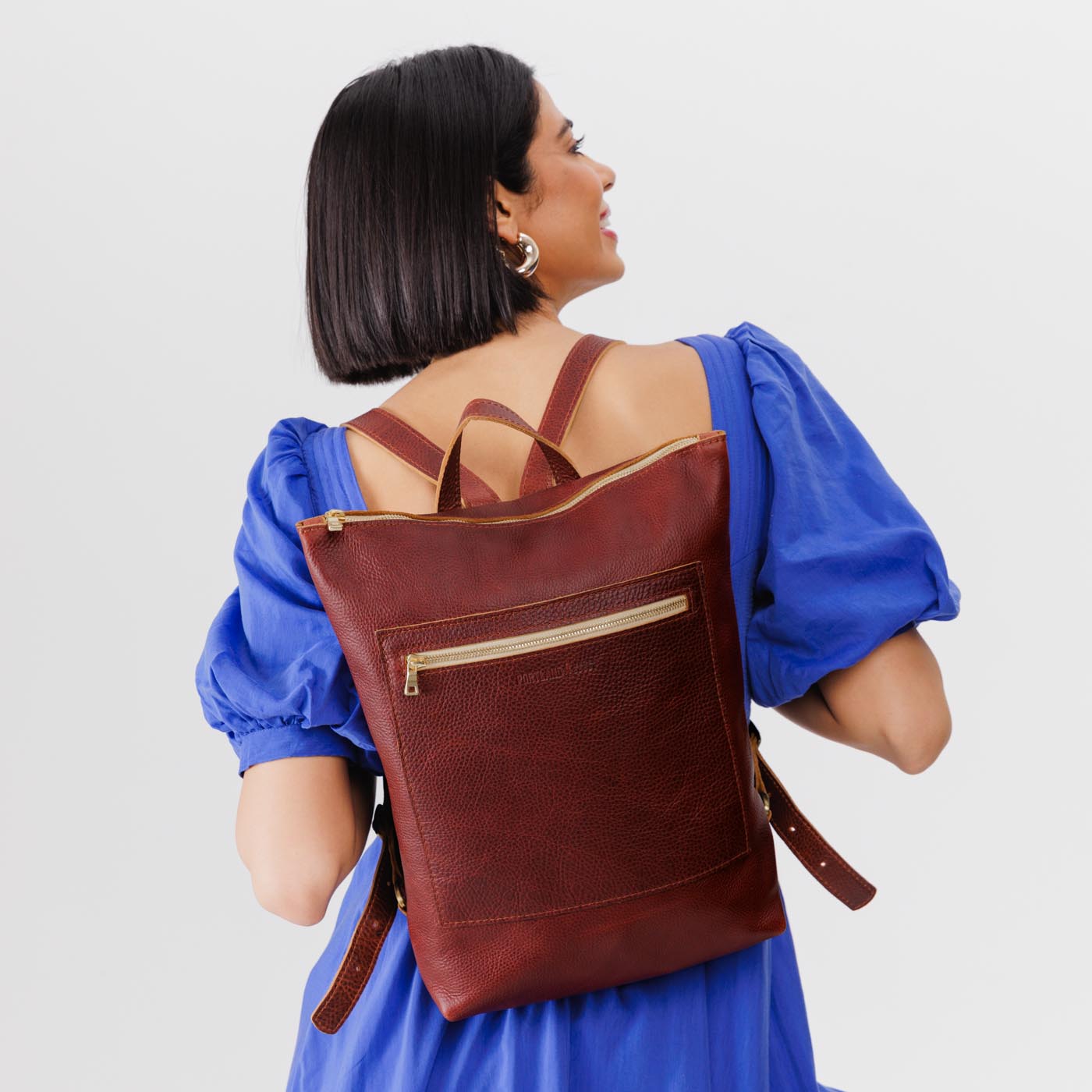 All Color: Cinnamon Bear | Model wearing rectangular slim leather laptop backpack