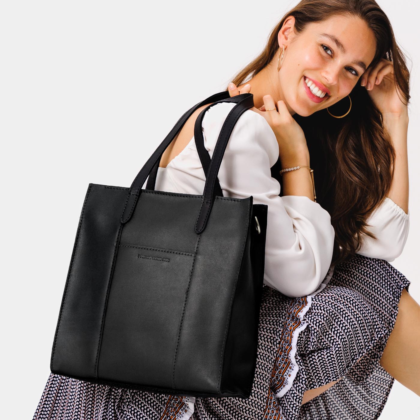  Black*North/South  | Structured large tote bag with overlapping panels and crossbody strap