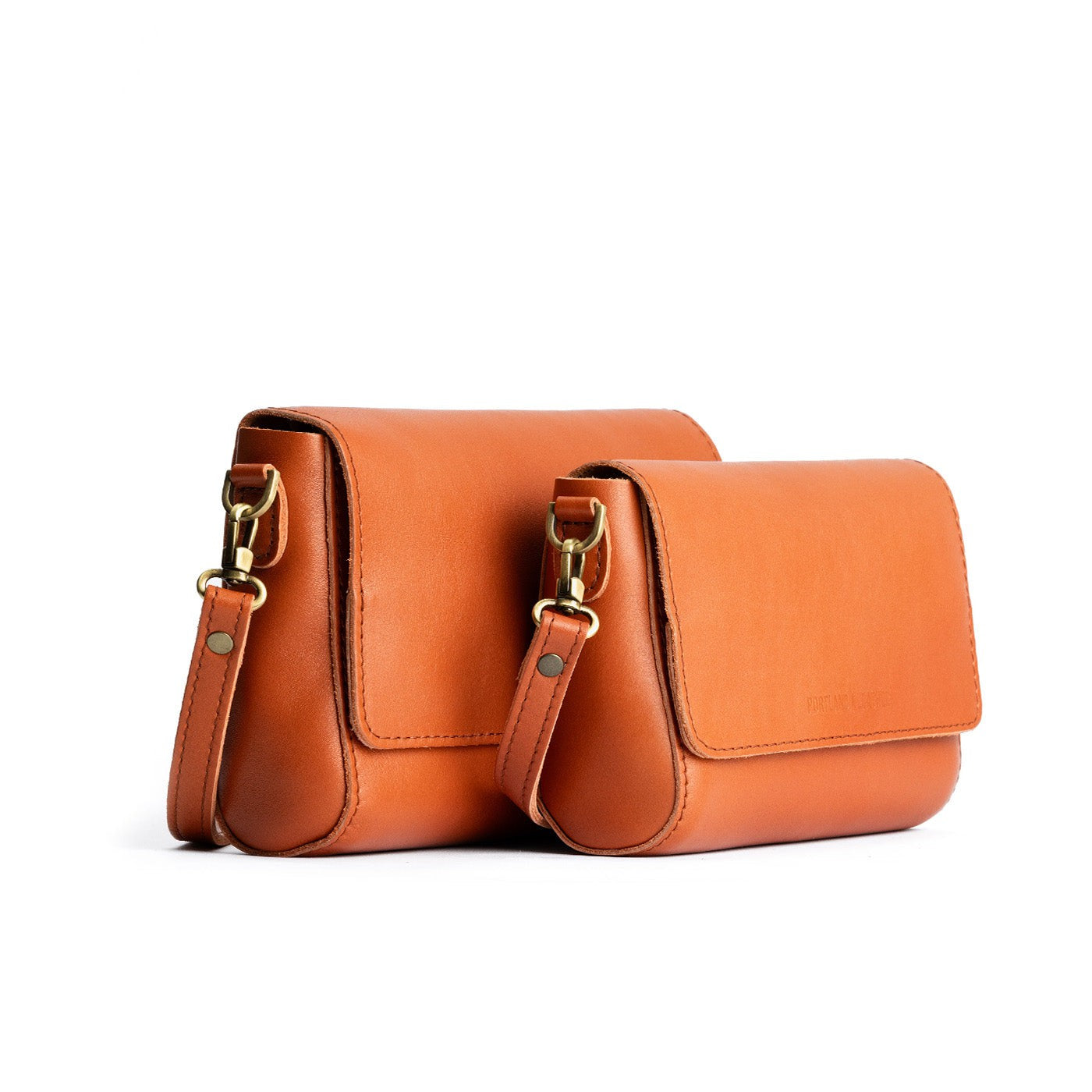 Persimmon | Side by side of both sizes of leather crossbody bag with magnetic messenger bag closure