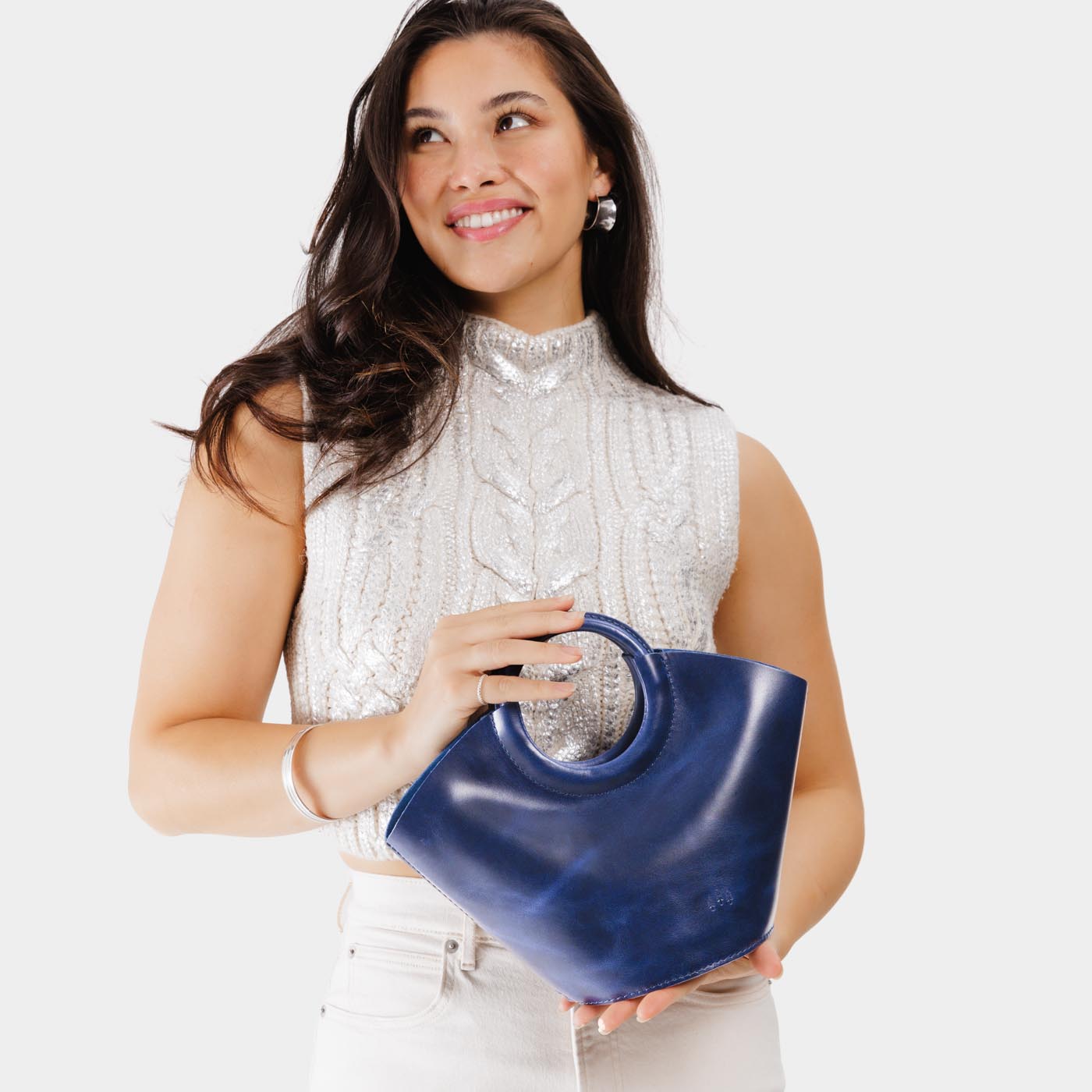 Cowboy Blue Small | Model holding structured leather hand bag with circular handles