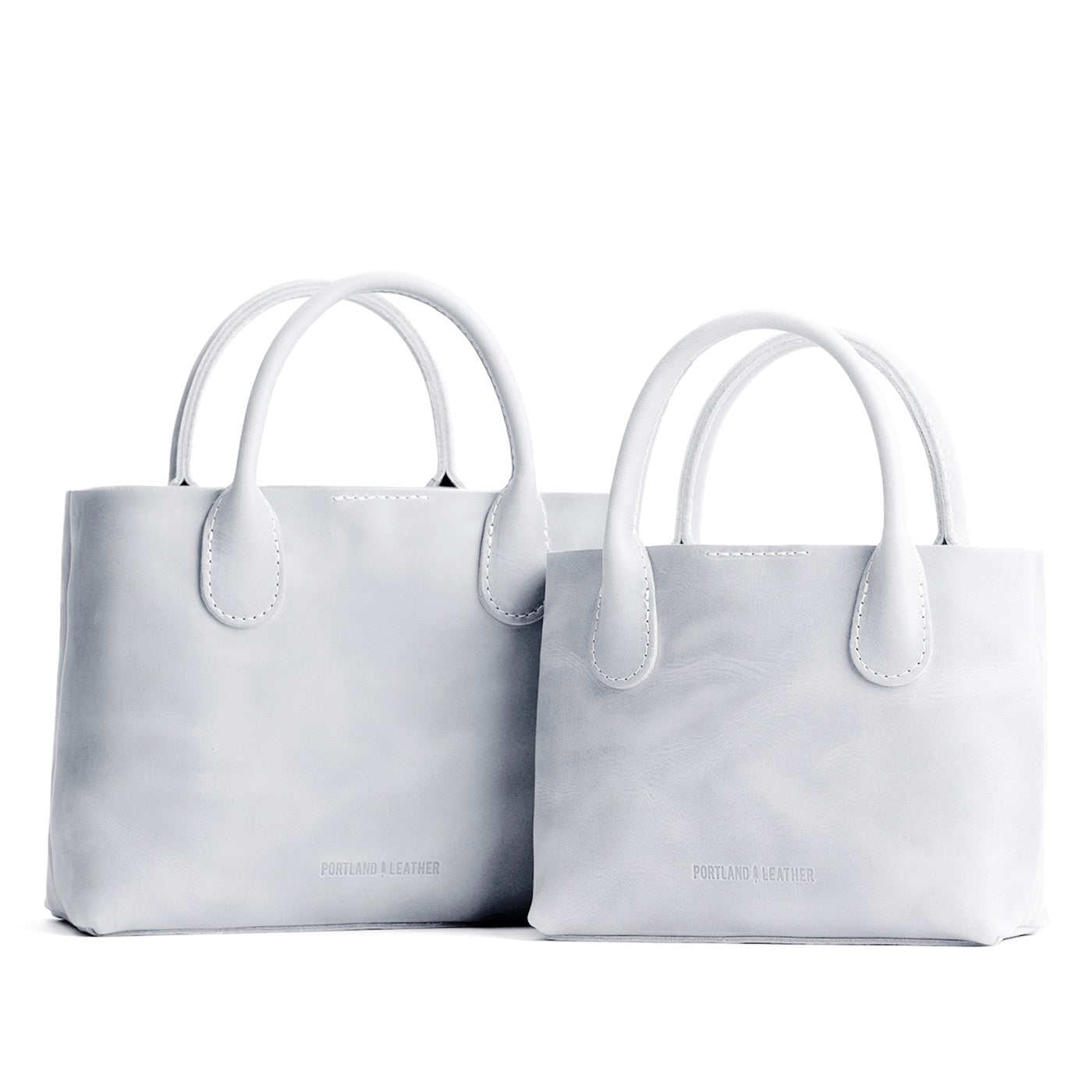 Beluga | Side by side of both tote purses with structured leather handles and crossbody strap