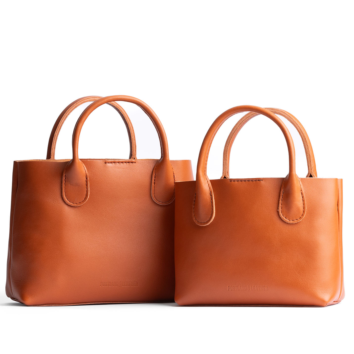 Persimmon | Side by side of both tote purses with structured leather handles and crossbody strap