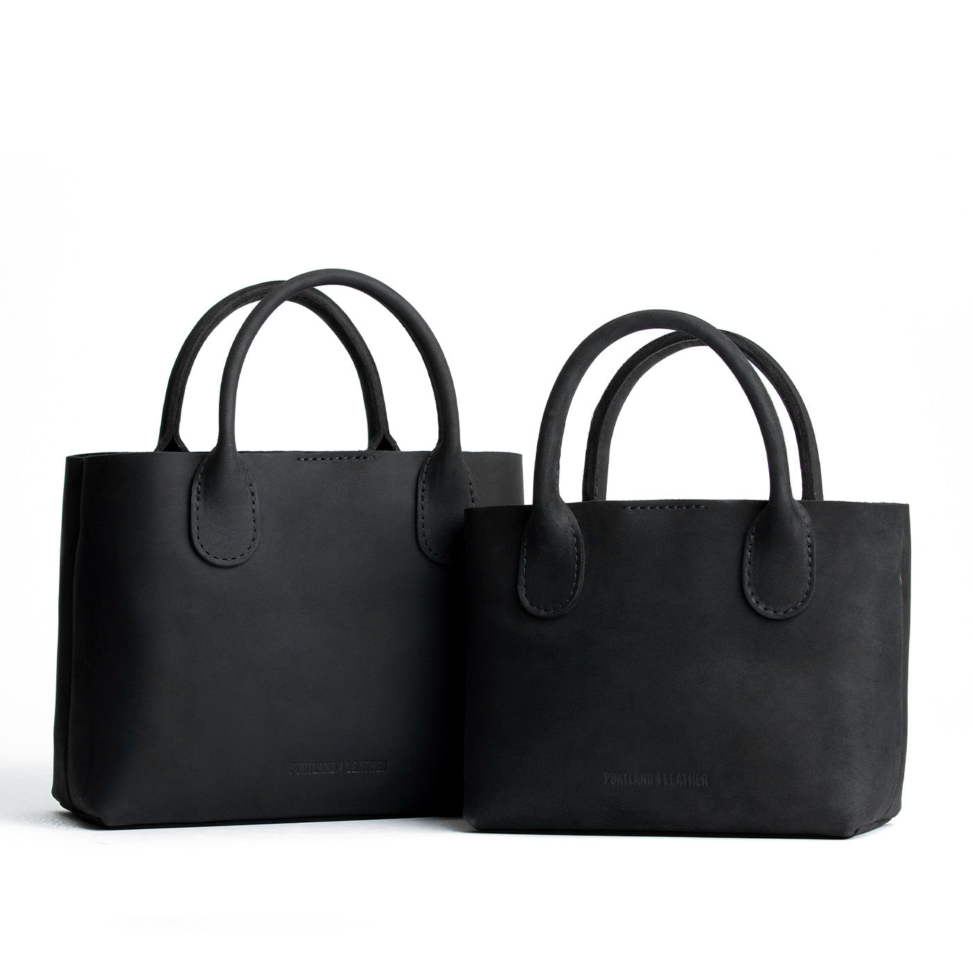 Shadow Black | Side by side of both tote purses with structured leather handles and crossbody strap