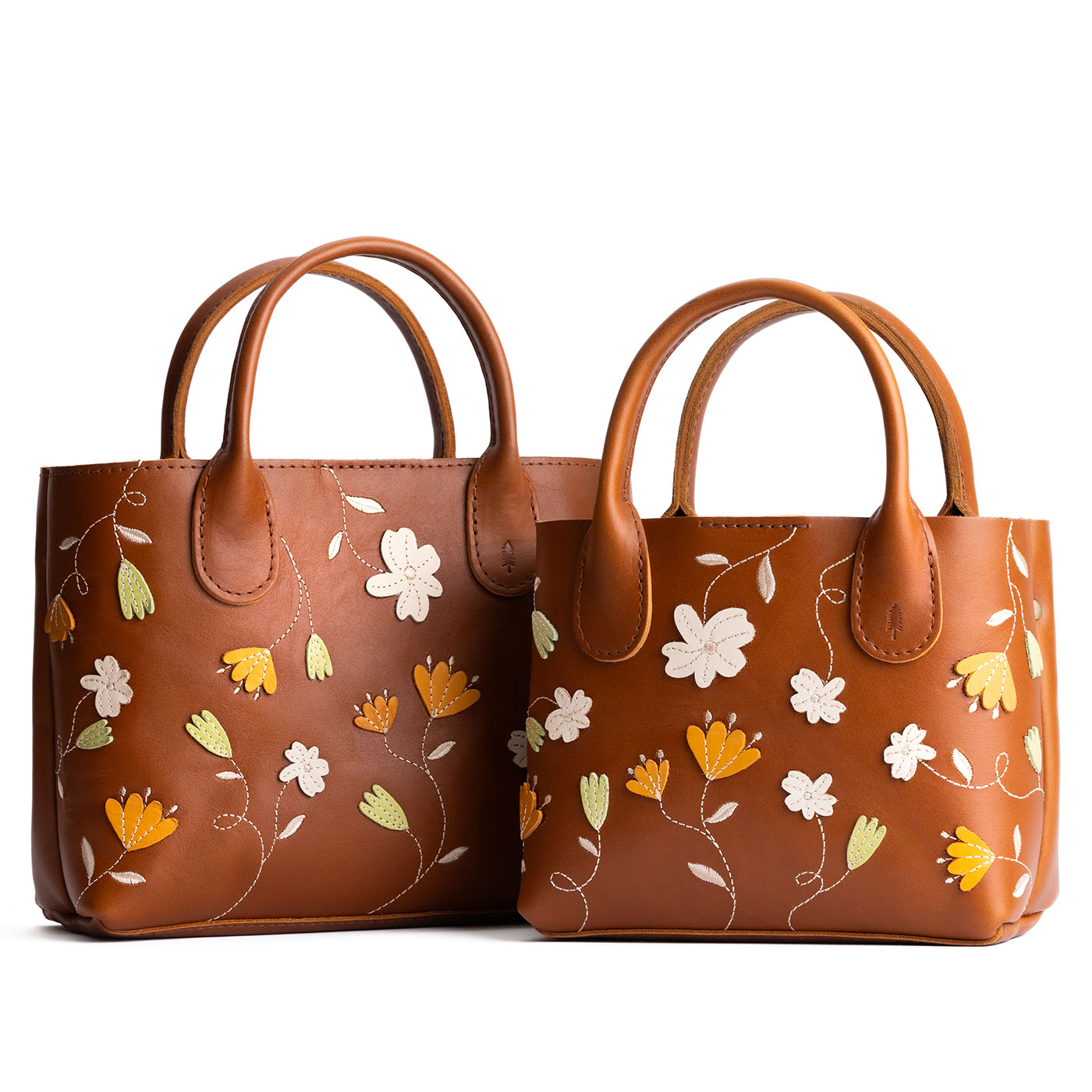 Folklore Honey | Petite tote purse with embroidered flower design, structured leather handles, and crossbody strap