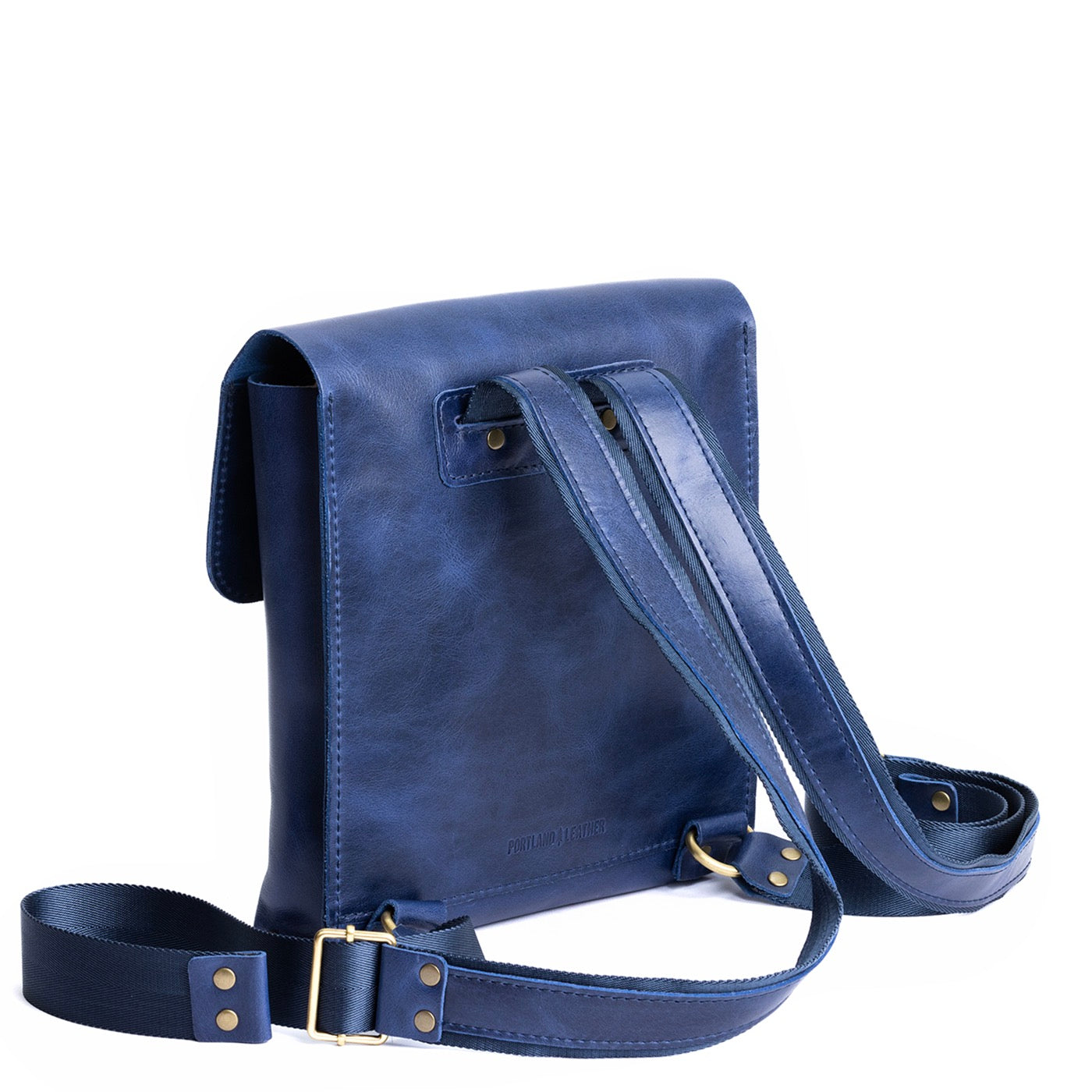 Cowboy Blue | Rectangular backpack with leather lined nylon straps and magnetic flap closure