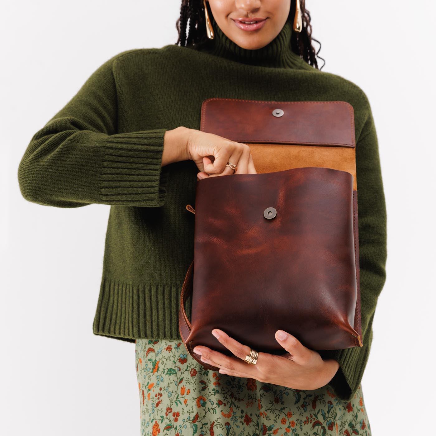 Timber | Model holding rectangular backpack with leather lined nylon straps and magnetic flap closure