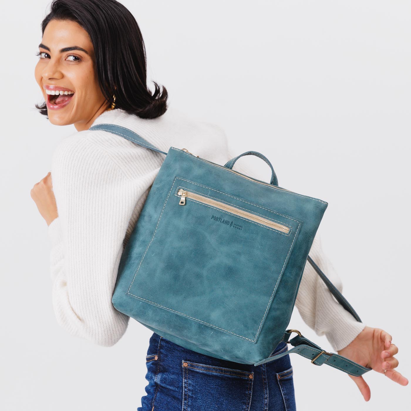 All Color: Aqua | Model wearing square slim leather tote backpack