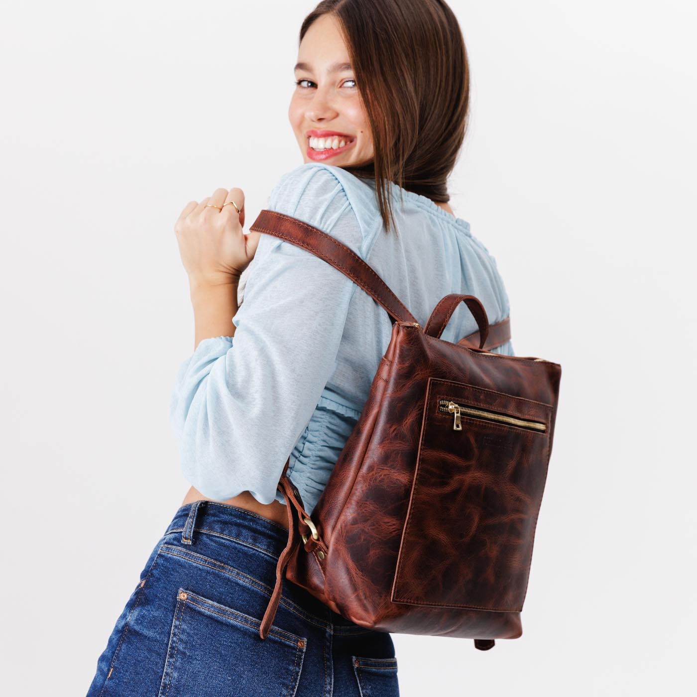 All Color: Lava | Model wearing square slim leather tote backpack