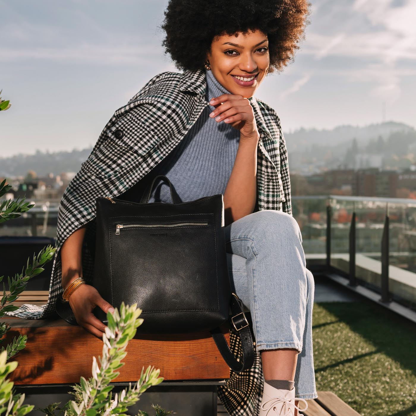 All Color: Pebbled--black | Model holding square slim leather tote backpack