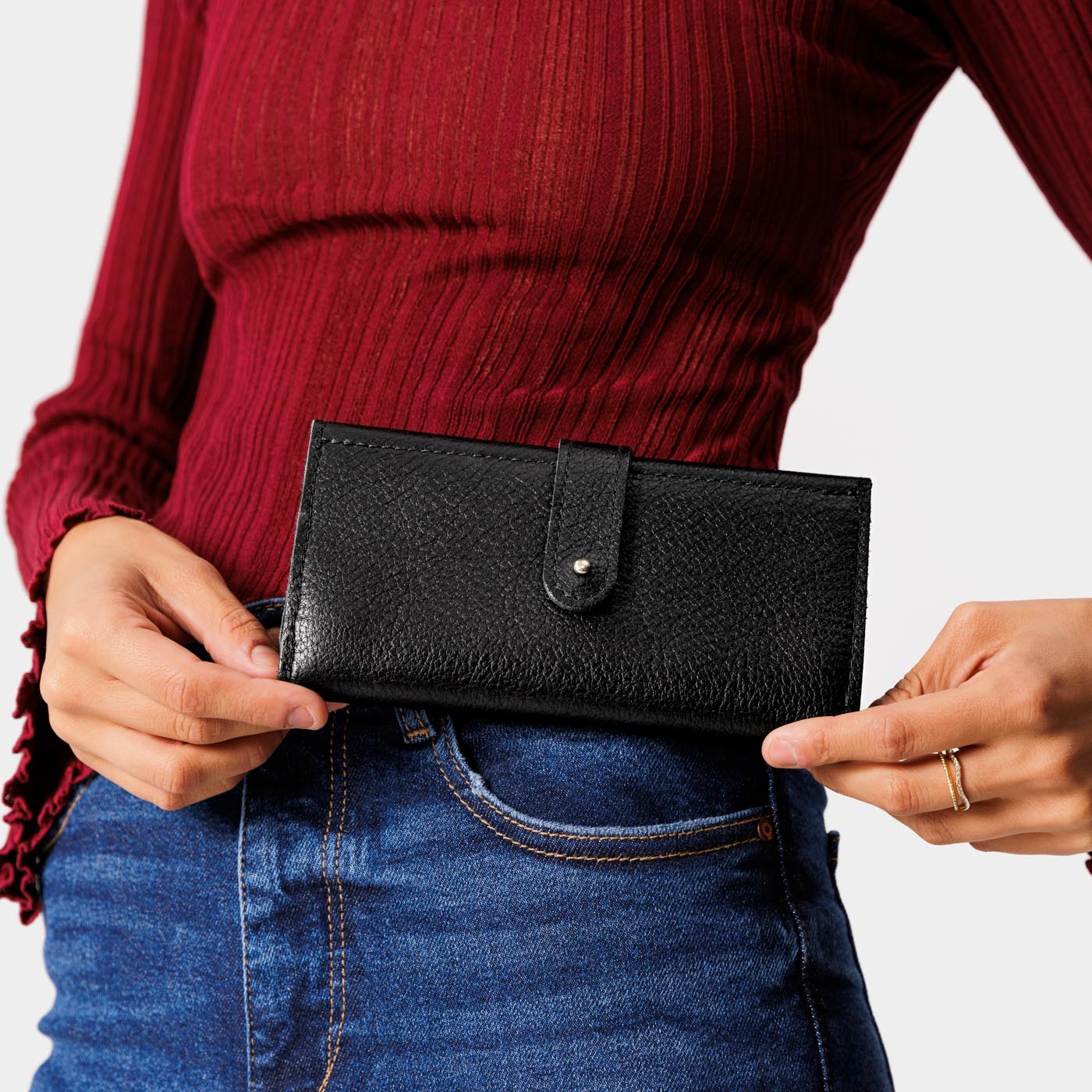 Pebbled--black | Model holding leather wallet with Sam Browne closure