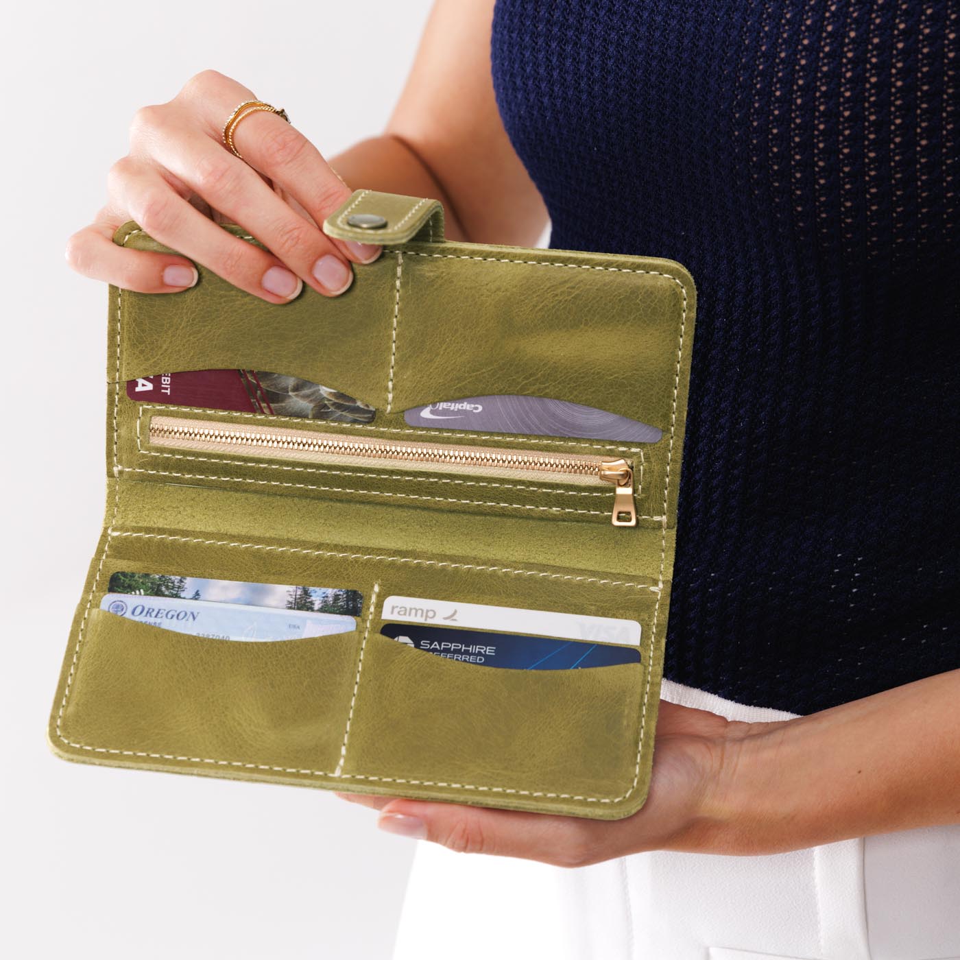 Anjou | Model holding leather wallet with snap open