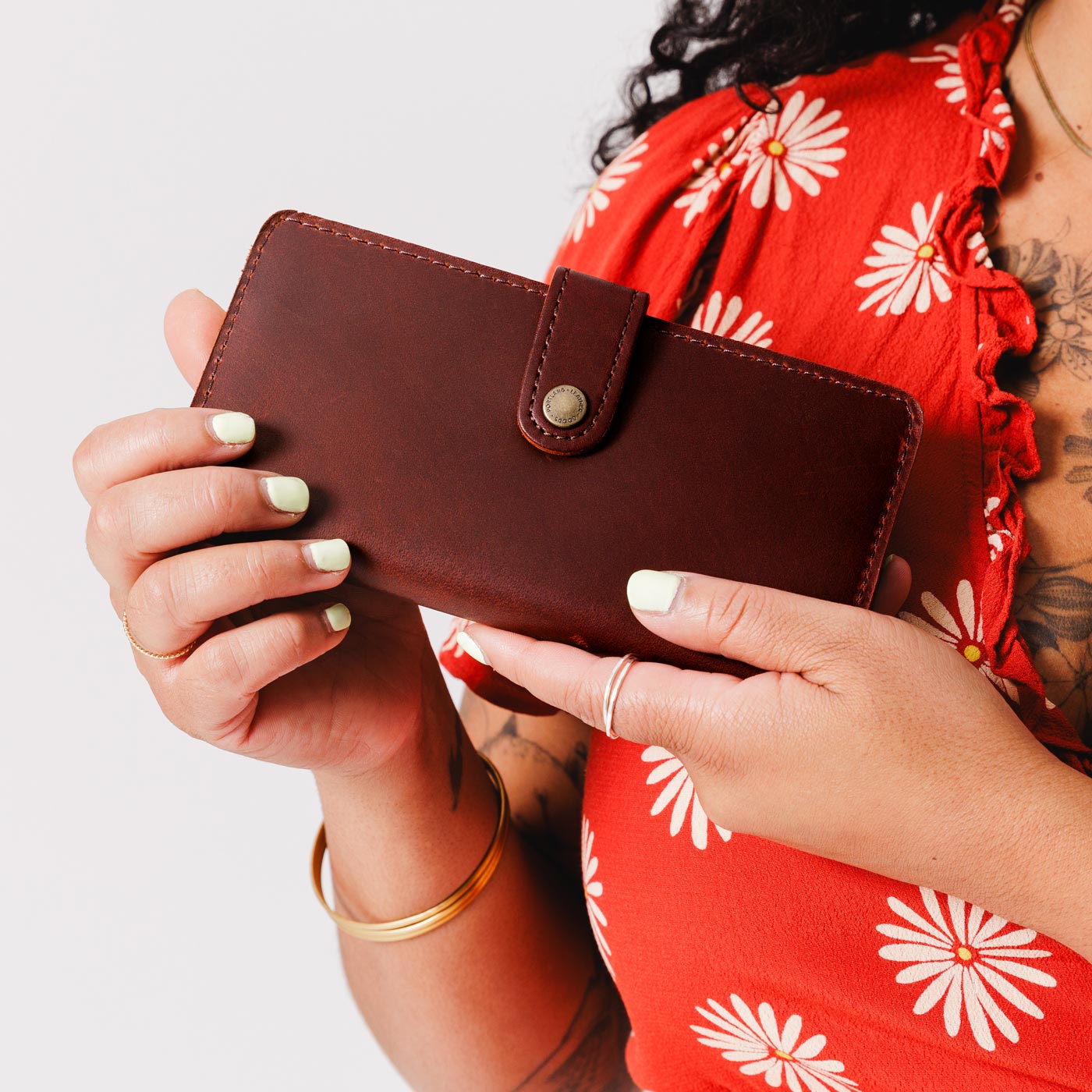 Cognac | Model holding leather wallet with snap closed