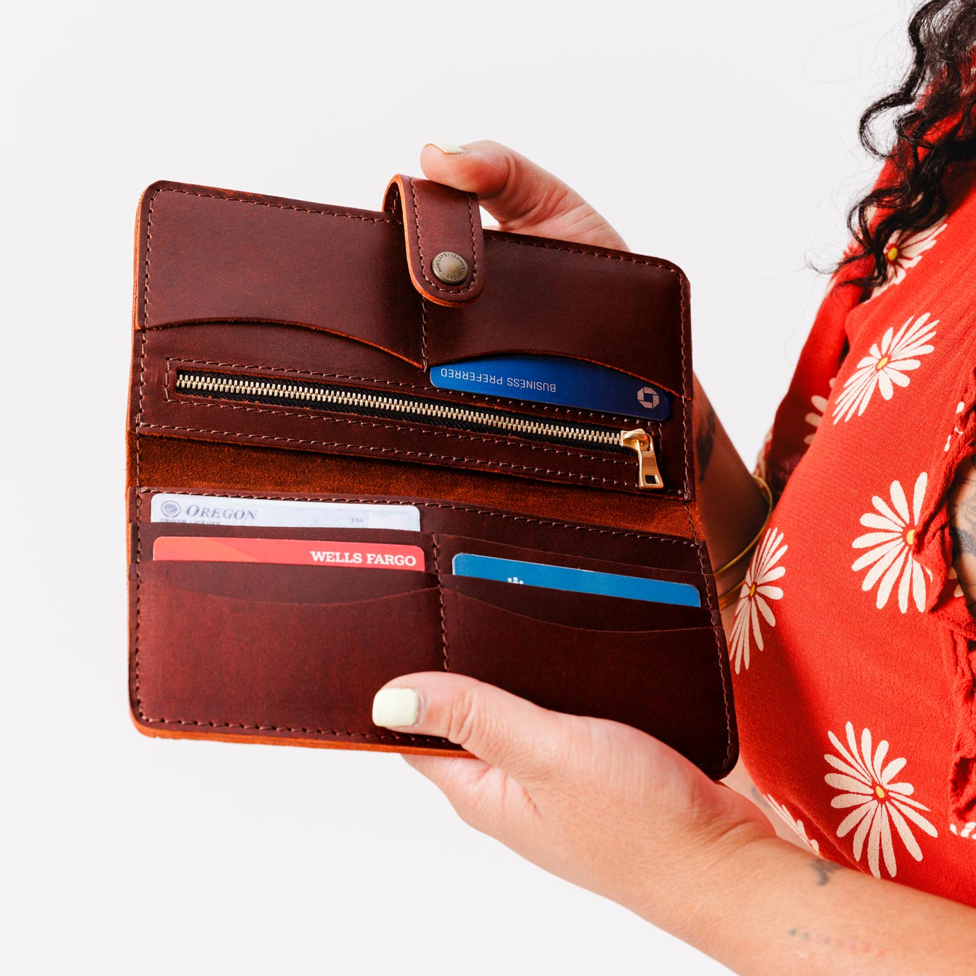 Cognac | Model holding leather wallet with snap open