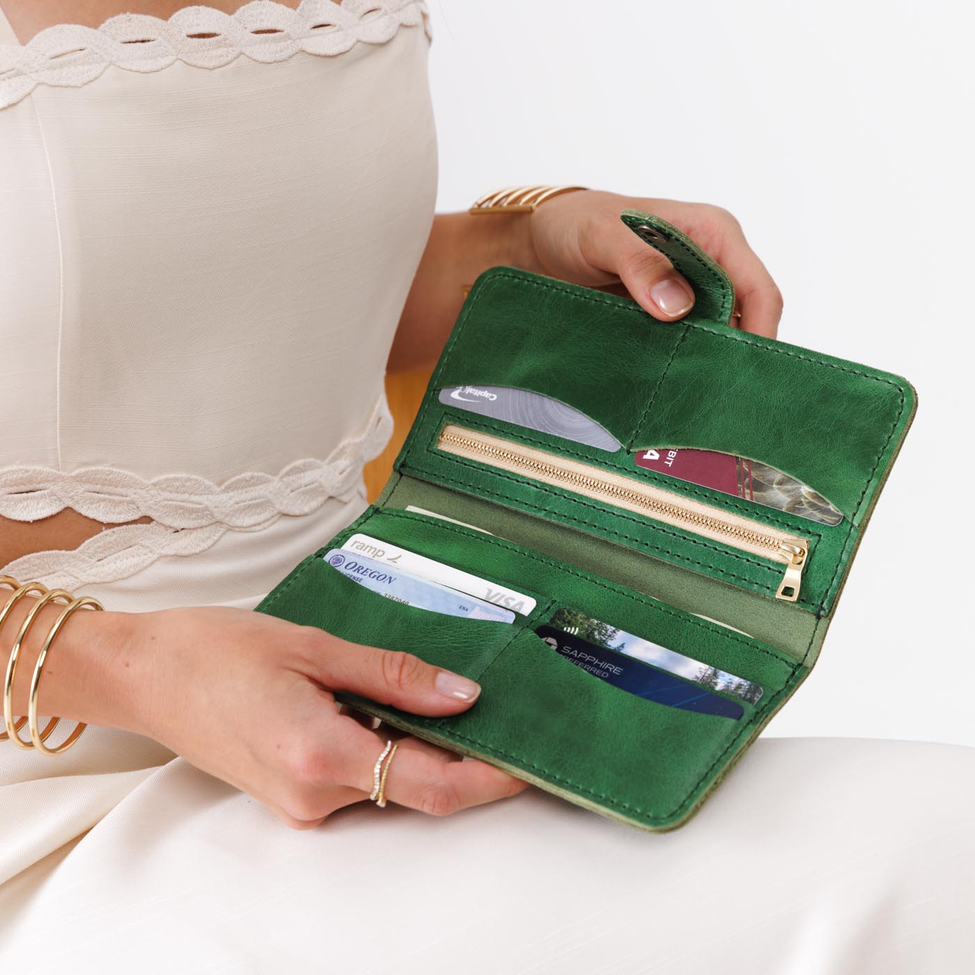 Cowboy Mint | Model holding leather wallet with snap open