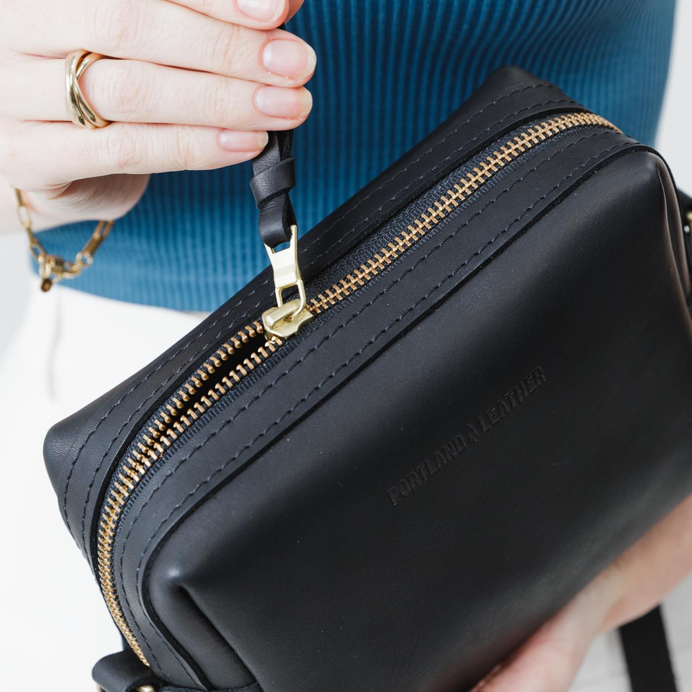  Black | Square crossbody bag with top zipper and leather pull tab