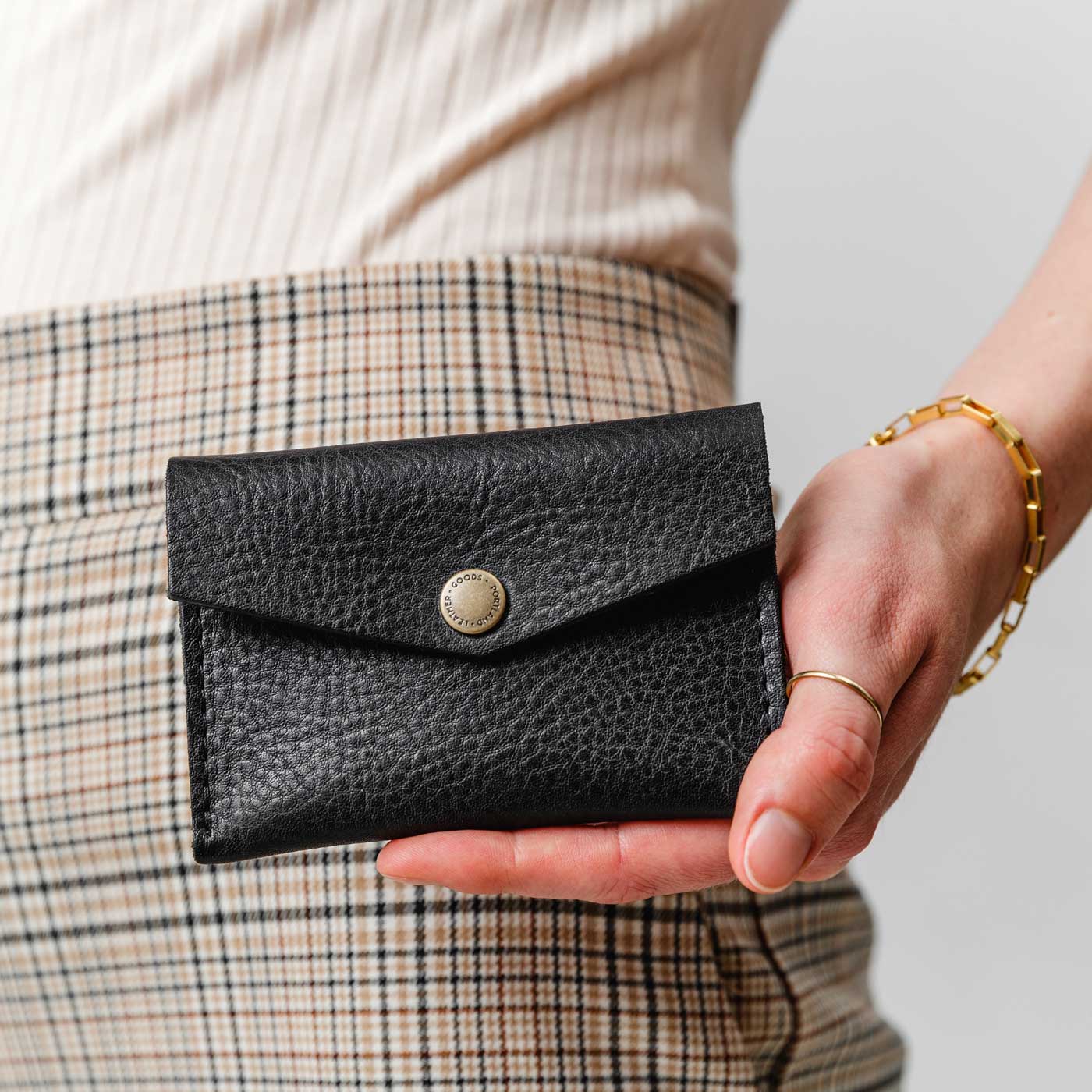 Pebbled--black | Model holding small leather envelope card wallet