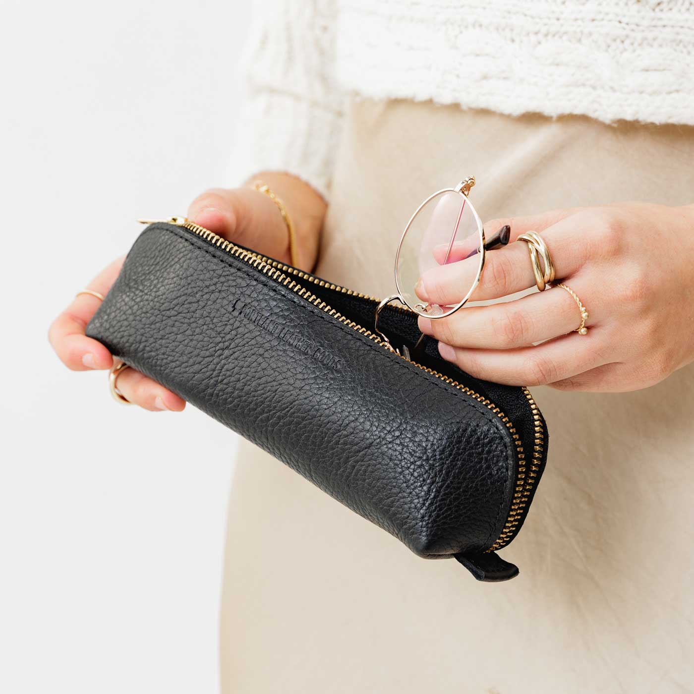 All Color: Pebbled--black | Leather pouch with curved seams and top zipper