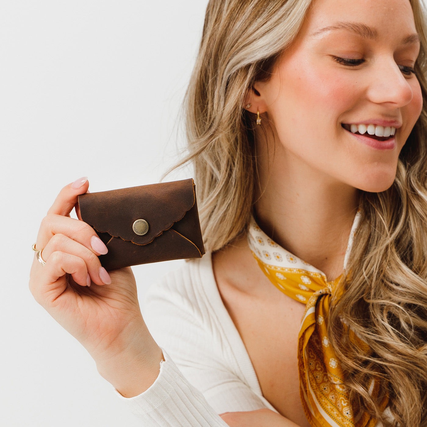 Canyon | Model holding small leather wallet with scalloped edge