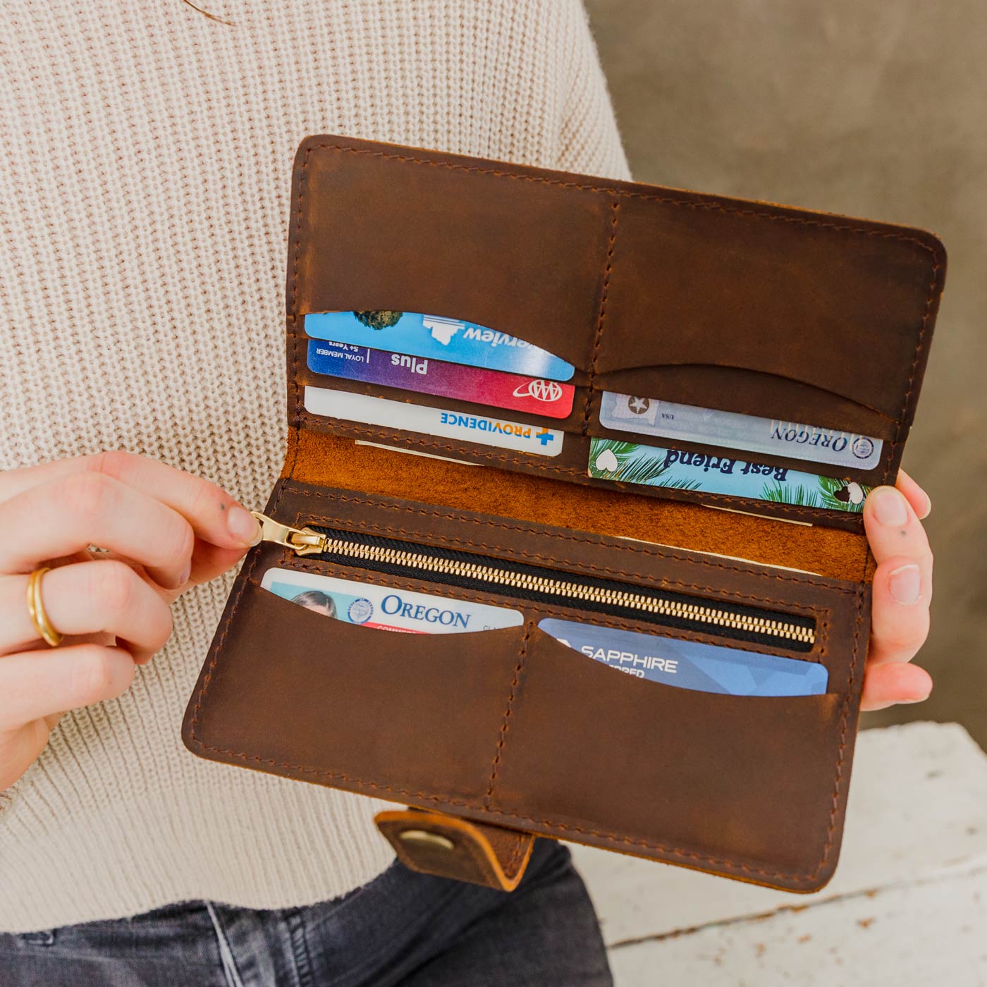 Canyon | Model holding leather wallet with snap open