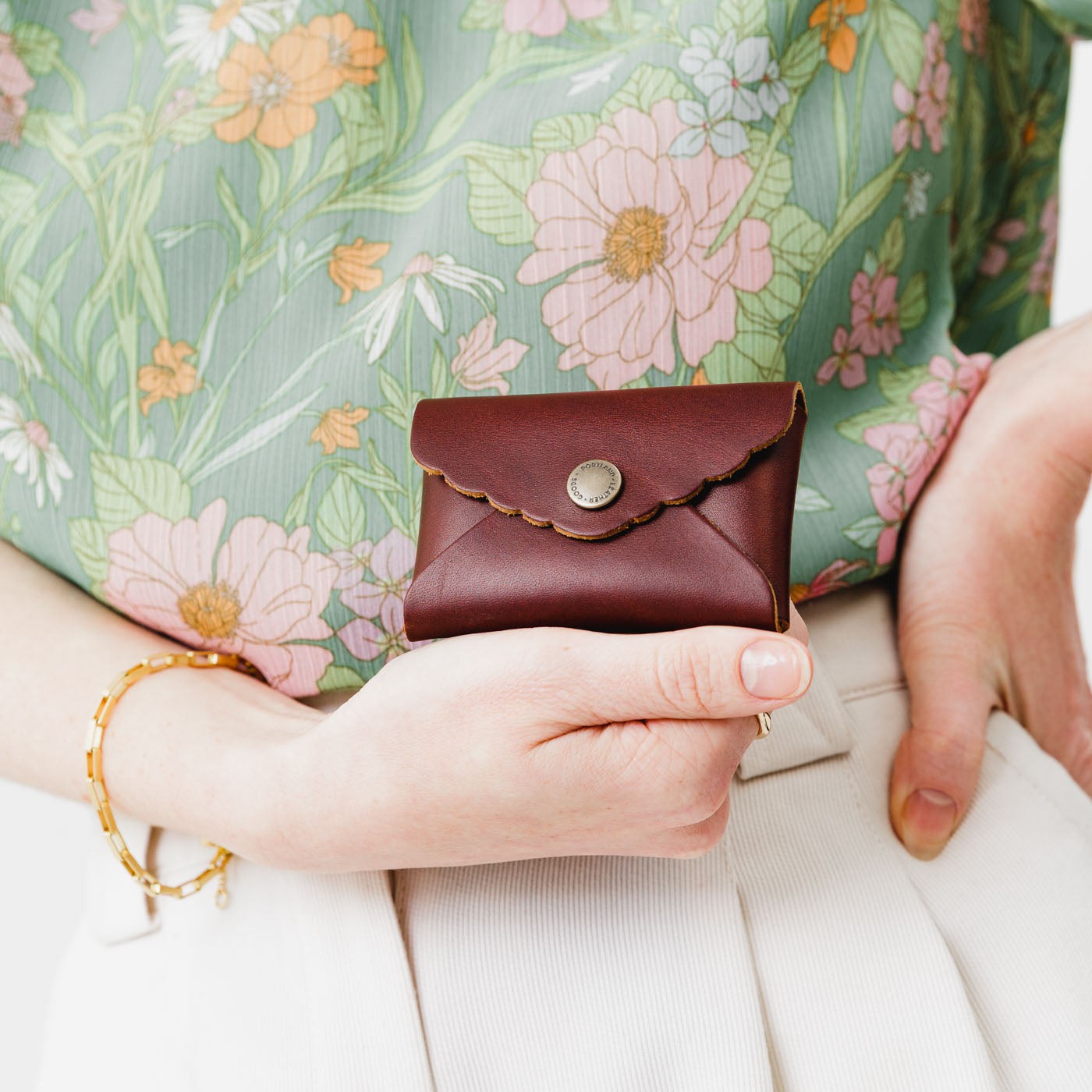 Cognac |  Model holding small leather wallet with scalloped edge