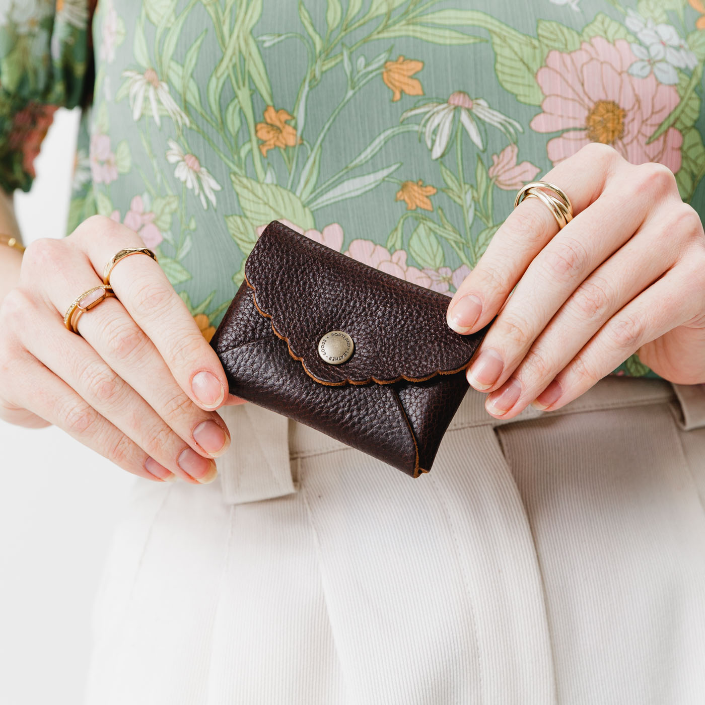 Coldbrew | Model holding small leather wallet with scalloped edge