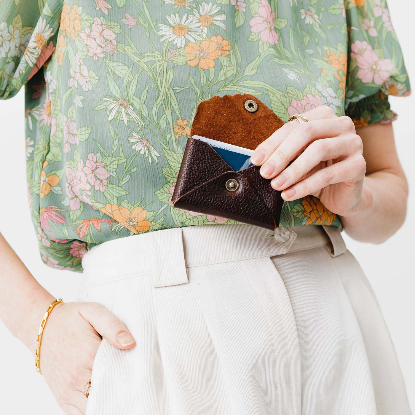 Coldbrew | Model holding small leather wallet with scalloped edge open