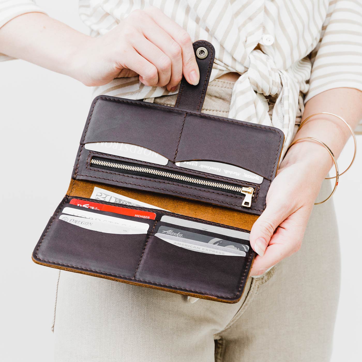 Grizzly | Model holding  leather wallet with snap open