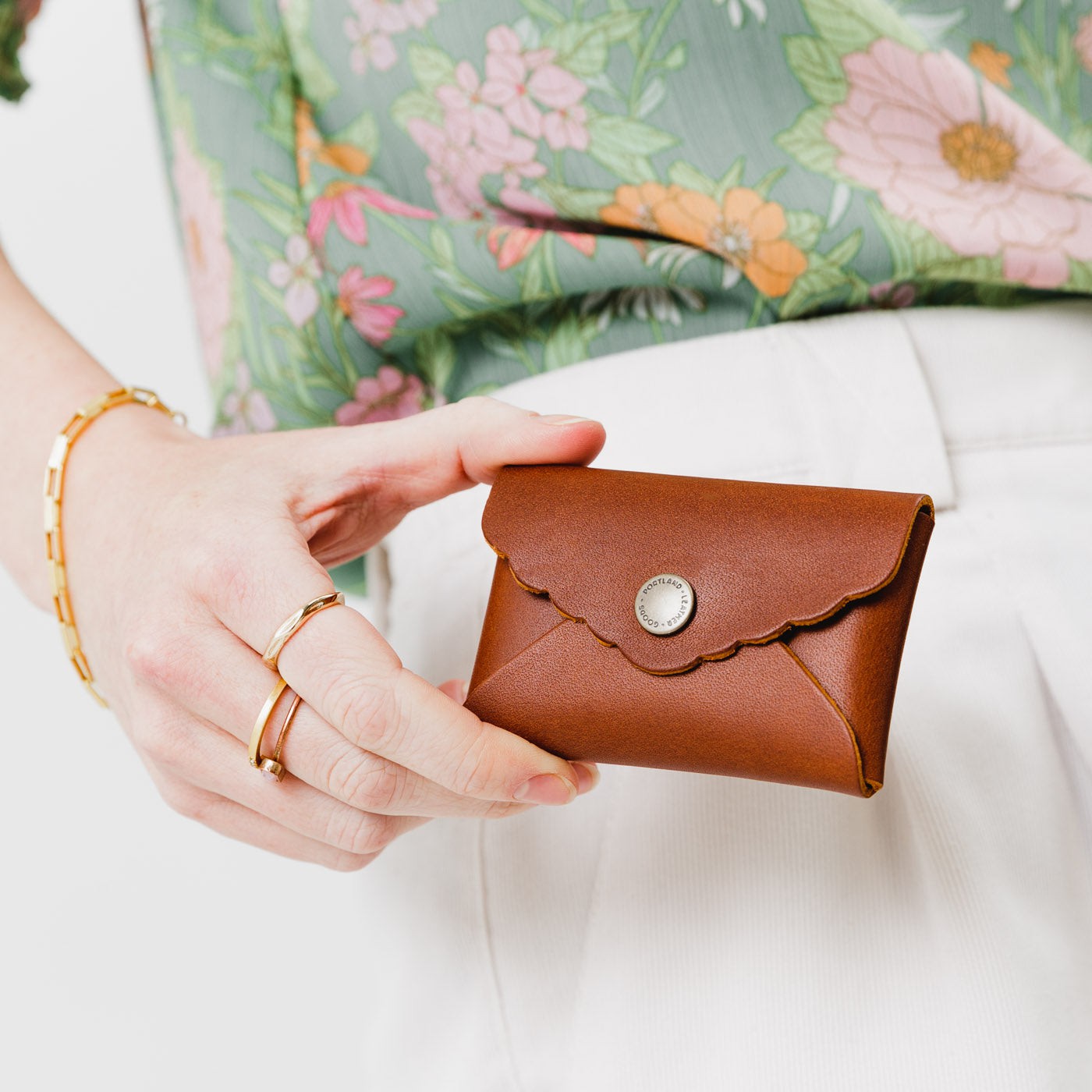 Honey | Model holding small leather wallet with scalloped edge