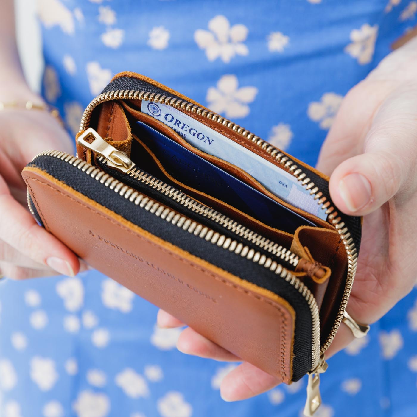 Honey | Model holding small leather wallet with zipper open