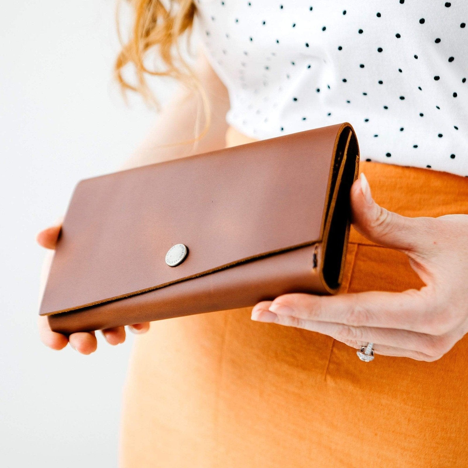 Honey | Model holding leather wallet with snap closure