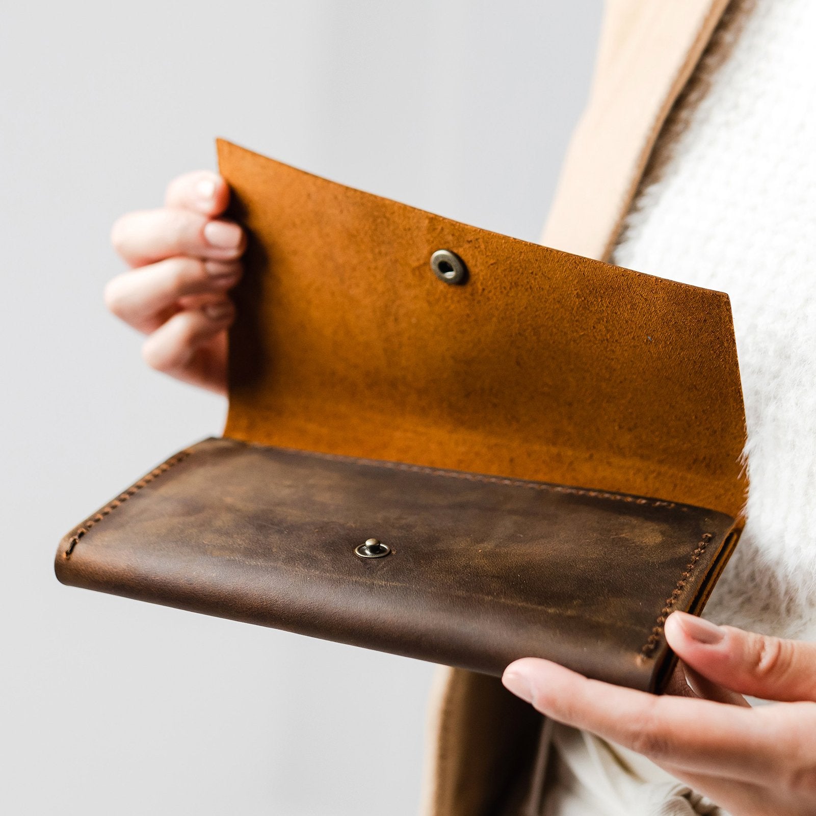 Canyon | Model holding leather wallet with snap closure open