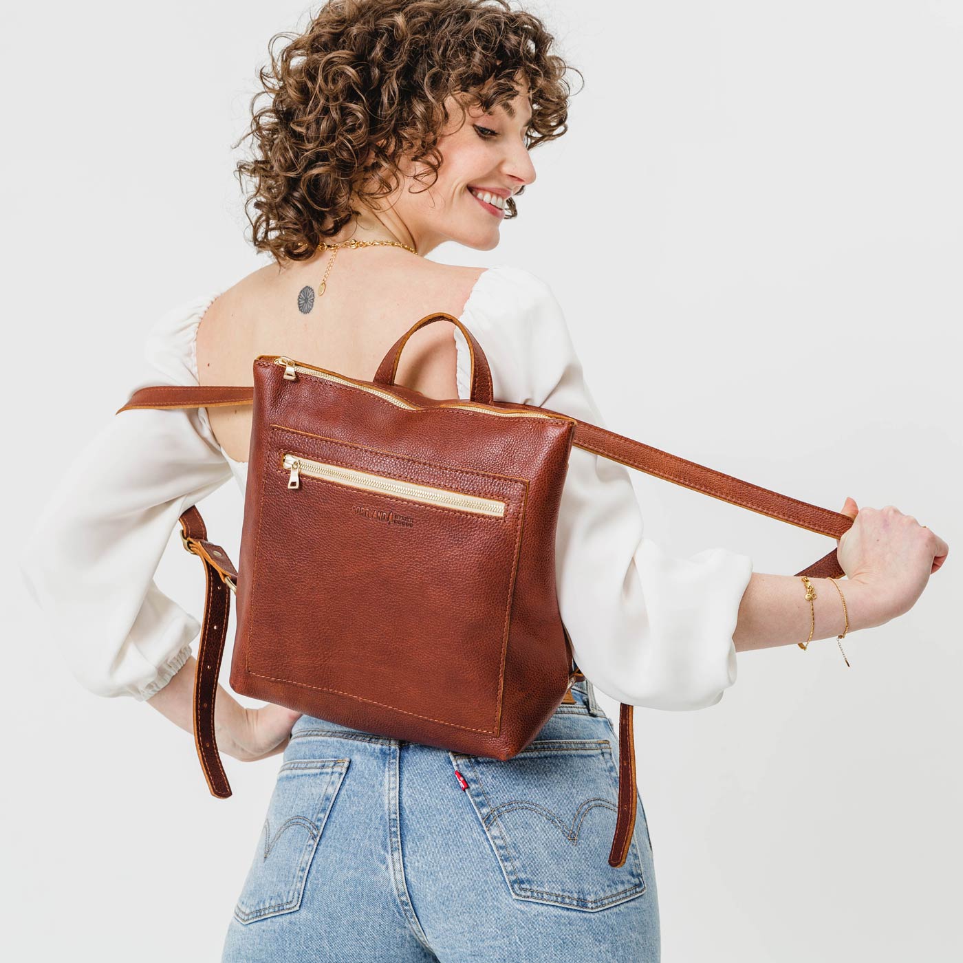 All Color: Nutmeg | Model wearing square slim leather tote backpack